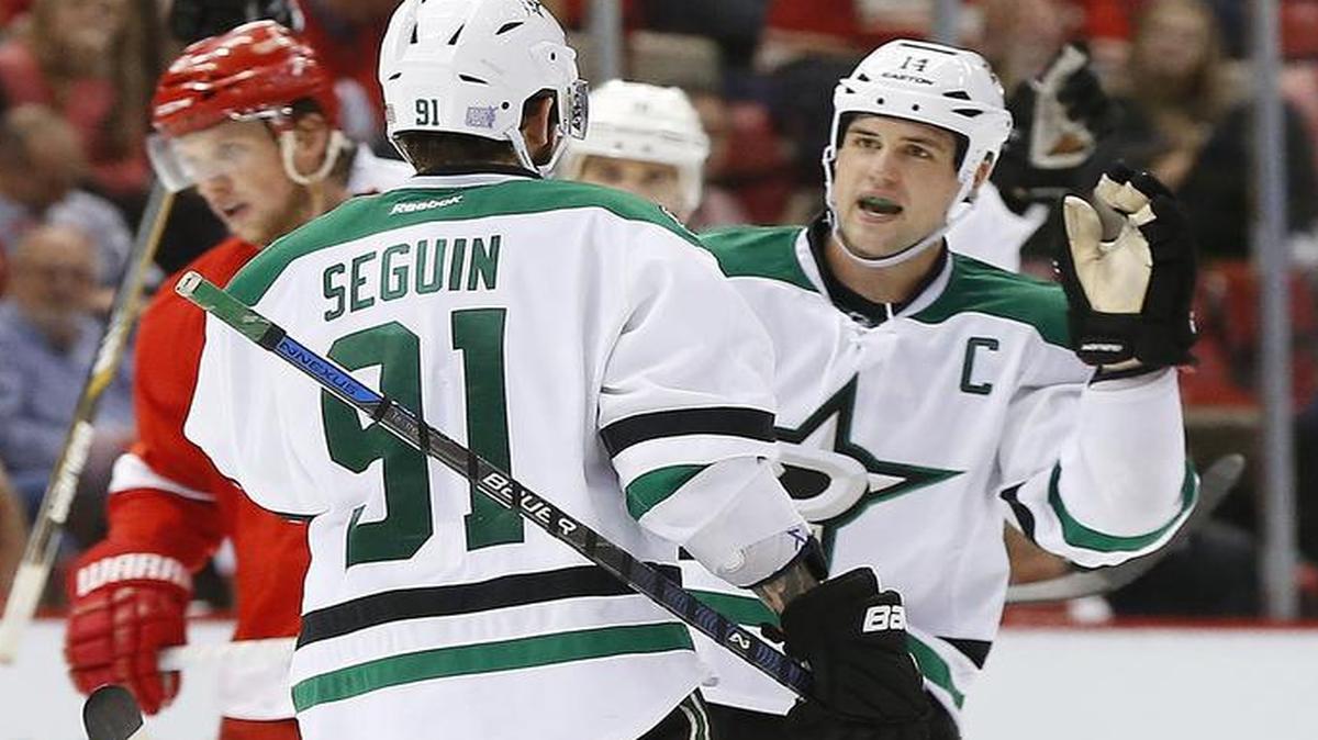 Dallas Stars left wing Jamie Benn, right, celebrates Tyler Seguin’s (91) empty net goal against the Detroit Red Wings in the third period of an NHL hockey game, Sunday, Nov. 8, 2015 in Detroit. Dallas won 4-1.