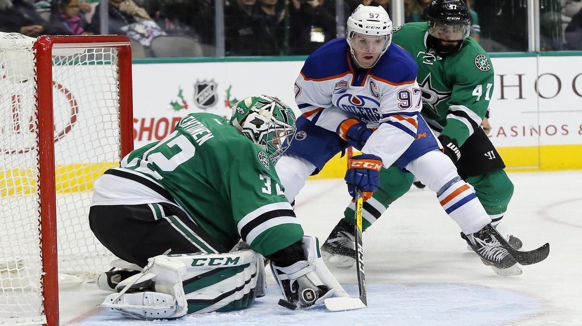 Dallas Stars goalie Kari Lehtonen, left, was under assault by Edmonton Oilers center Connor McDavid. The 19-year-old McDavid netted his first career hat trick, with the first two goals coming off Lehtonen.
