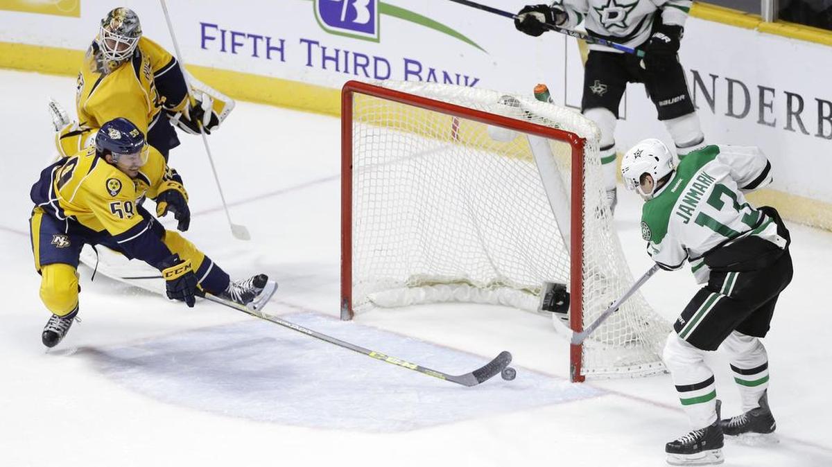 Dallas Stars center Mattias Janmark scores the winning goal in overtime as Nashville Predators defenseman Roman Josi tries to block the shot. The Stars won 3-2.