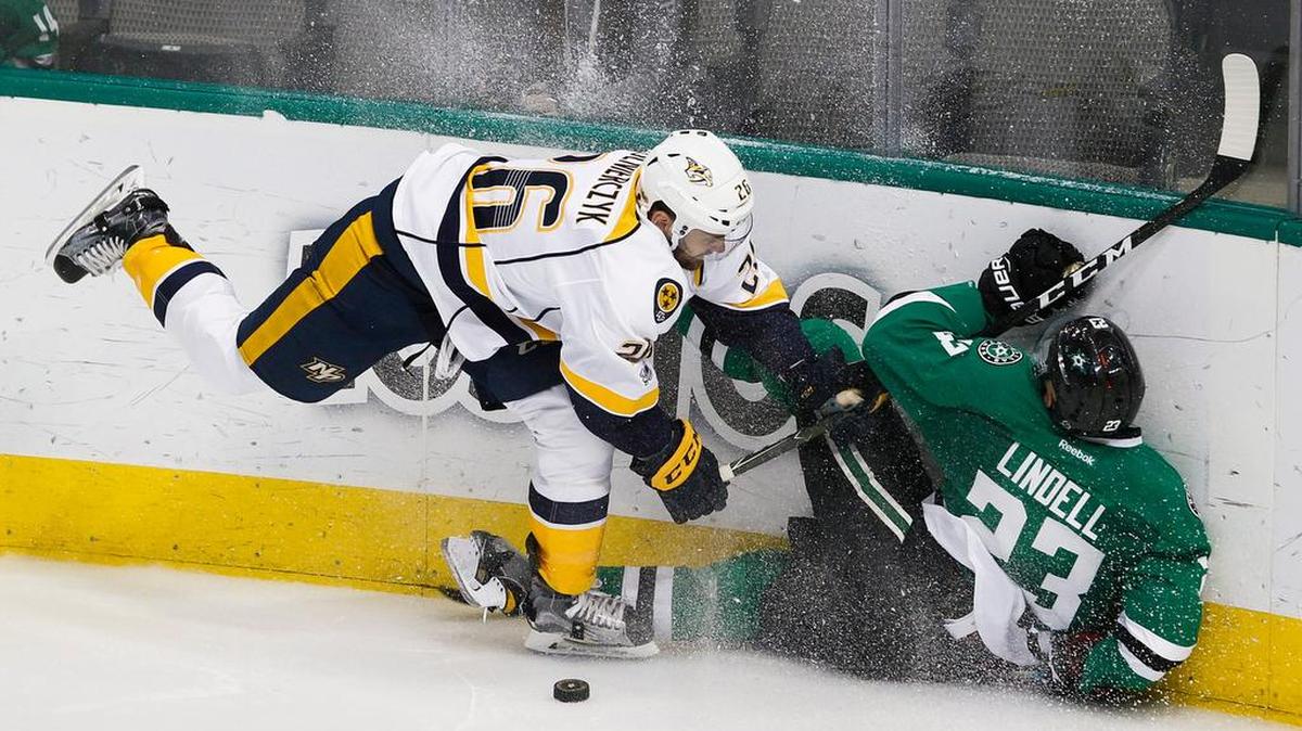 Nashville Predators left wing Harry Zolnierczyk (26) shoves Dallas Stars defenseman Esa Lindell (23) to the boards during the third period as the Predators hammered the Stars in more ways than one 7-3 on Thursday.
