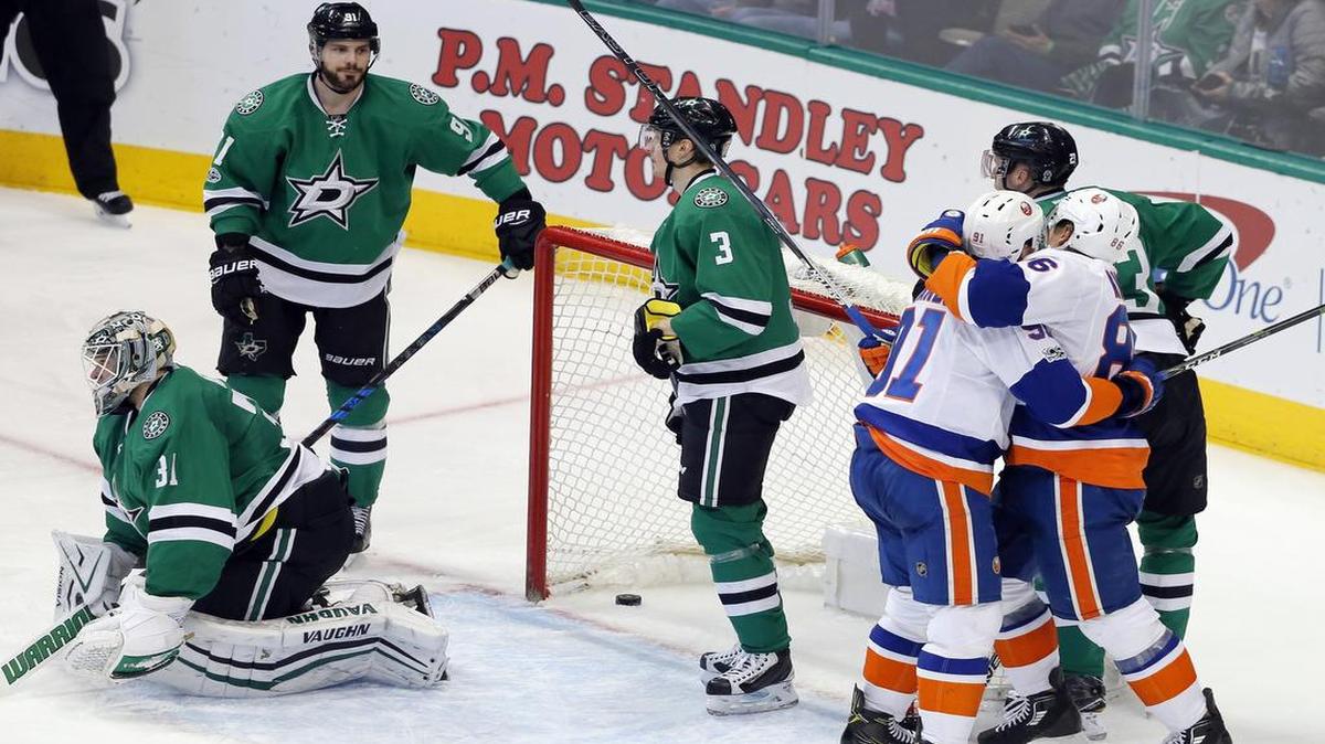 New York Islanders John Tavares (91) and Nikolay Kulemin, right, celebrate a goal by Kulemin, the last of four in a row by New York, scored against Dallas Stars goalie Antti Niemi (31). Stars Tyler Seguin (91) and John Klingberg (3) try to figure out what happened.