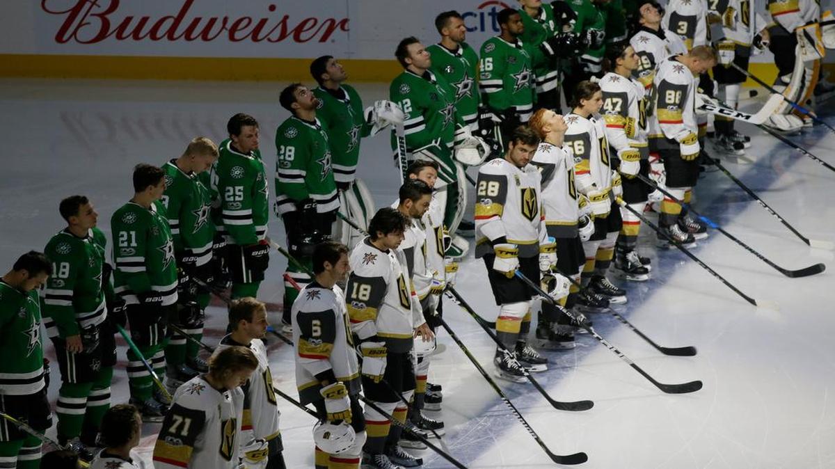 The Dallas Stars and Vegas Golden Knights line up for a moment of silence for shooting victims in Las Vegas before an NHL hockey game in Dallas, Friday, Oct. 6, 2017.