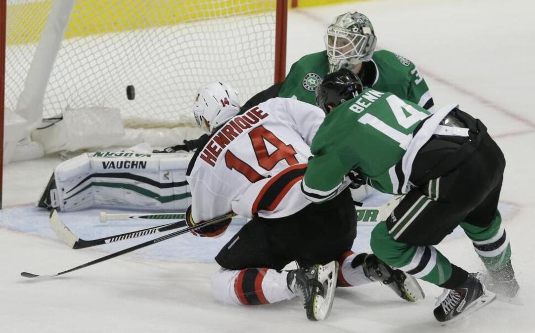 New Jersey Devils center Adam Henrique scores the overtime game winner against Dallas Stars left wing Jamie Benn and goalie Antti Niemi on Tuesday from the American Airlines Center in Dallas. New Jersey won 2-1.