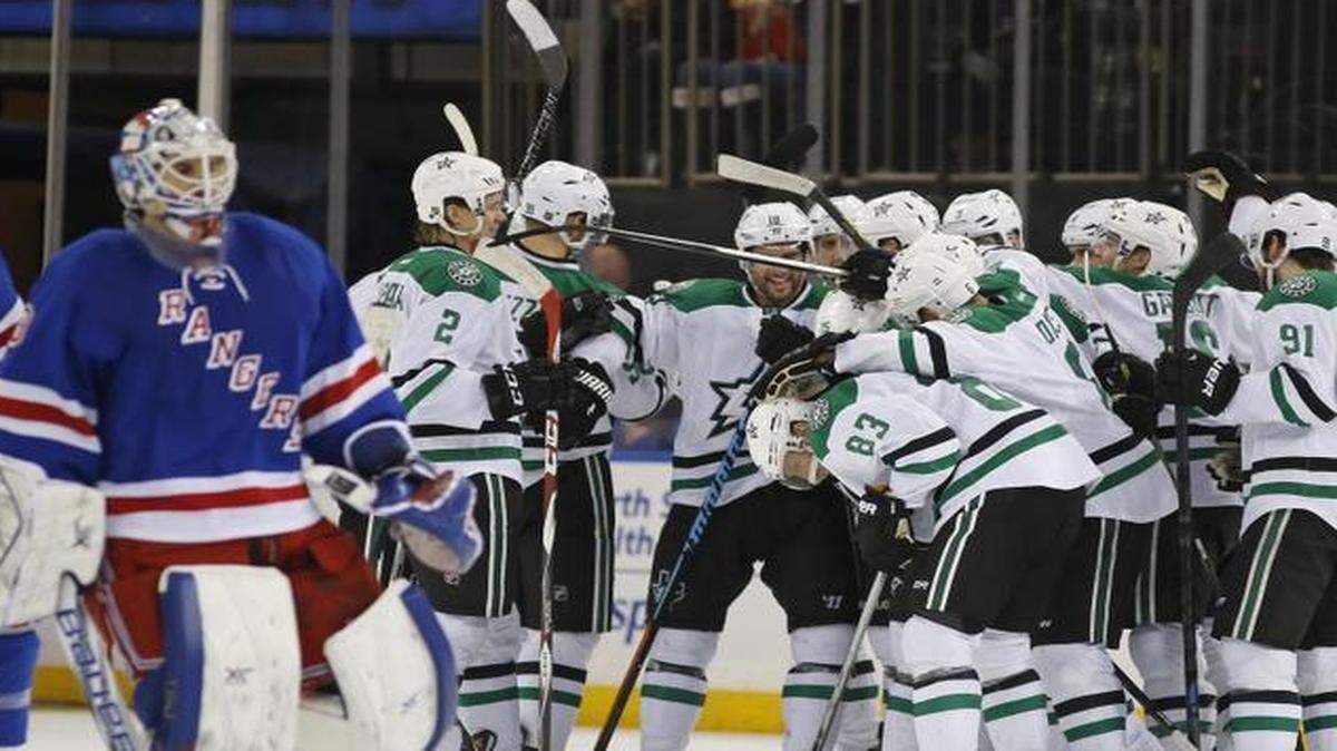 
The Stars celebrate after right wing Ales Hemskey scored 1:02 into overtime Sunday night, beating goalie Cam Talbot and the Rangers and snapping a three-game losing streak.



