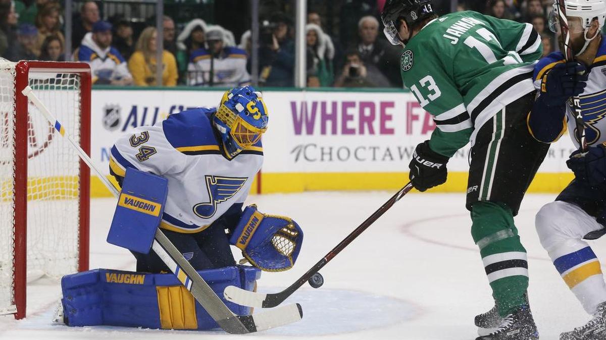 St. Louis Blues goaltender Jake Allen (34) makes a save on a shot by Dallas Stars center Mattias Janmark (13) during the first period Friday.