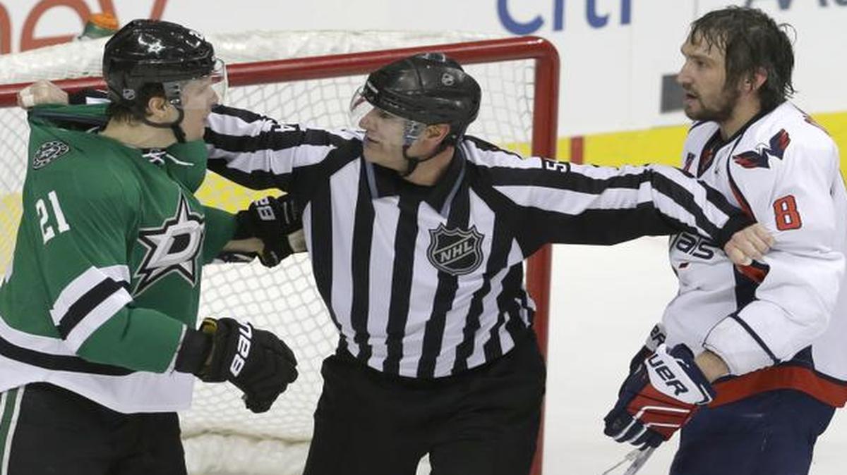
Linesman Greg Devorski (54) separates Washington Capitals’ Alex Ovechkin (8) and Dallas Stars’ Antoine Roussel (21) during the second period of an NHL hockey game Saturday, Jan. 17, 2015, in Dallas. 
