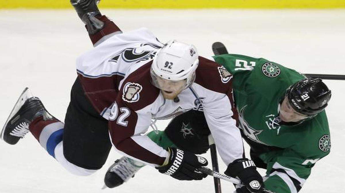 
Avalanche left wing Gabriel Landeskog, left, is knocked off his feet by Stars left wing Antoine Roussel during the third period Tuesday night.
