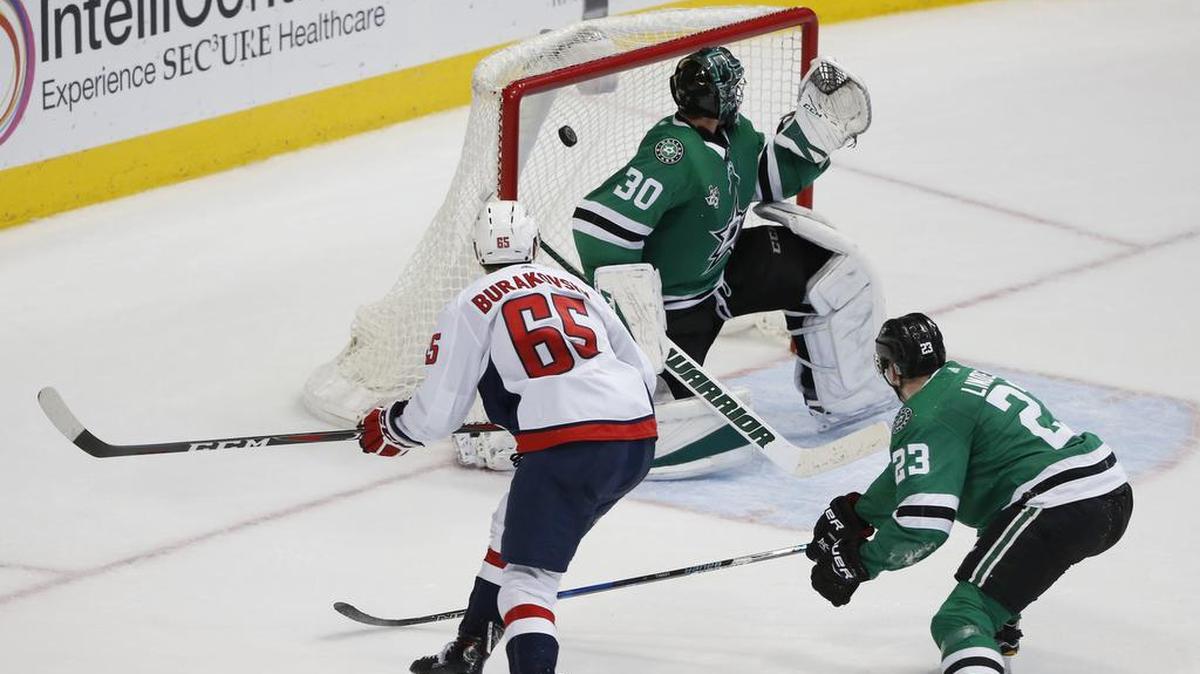Washington Capitals left wing Andre Burakovsky (65) scores the winning goal in overtime on Dallas Stars goalie Ben Bishop (30) as defenseman Esa Lindell (23) watches.