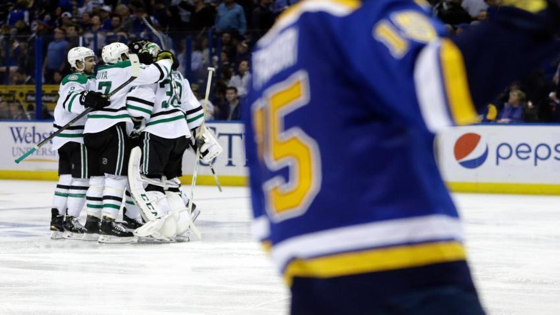 The Dallas Stars celebrate their 3-2 overtime victory as St. Louis Blues’ Robby Fabbri, right, skates past in Game 4 on Thursday.