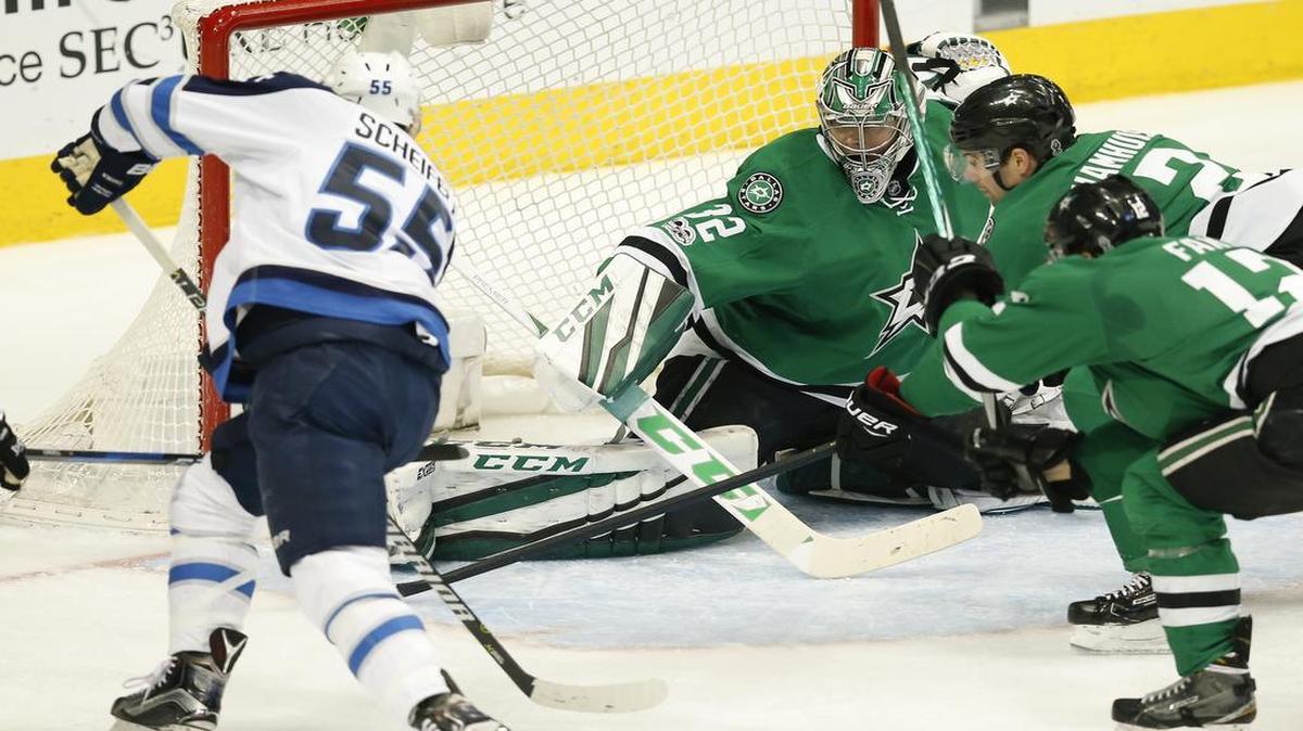 Winnipeg Jets center Mark Scheifele, left, shoots against Dallas Stars goalie Kari Lehtonen (32) during the second period. Scheifele scored twice in Winnipeg’s 4-3 victory over Dallas on Thursday.