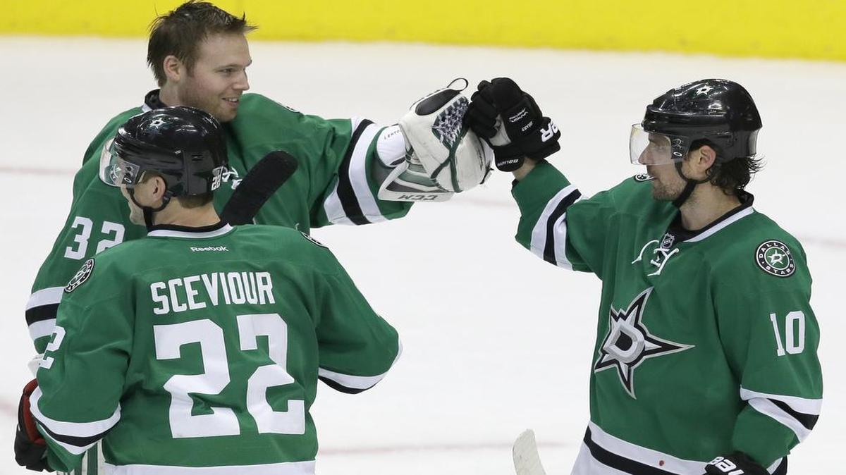 Stars left wing Patrick Sharp (10) celebrates with teammates goalie Kari Lehtonen and Colton Sceviour after their 6-5 victory over Carolina on Tuesday night.