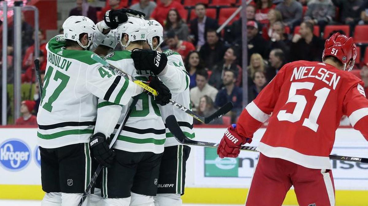 Dallas Stars center Jason Spezza, second from left, celebrates the first of his two goals Tuesday night as Detroit Red Wings center Frans Nielsen skates away.