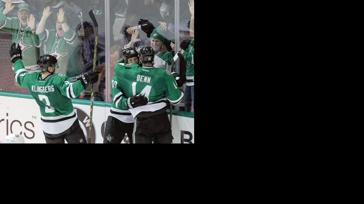 
Dallas Stars defenseman Jyrki Jokipakka, left, and left wing Jamie Benn (14) celebrate with center Cody Eakin (20) after Eakin’s winning goal 2:18 into overtime Tuesday against the New York Islanders.
