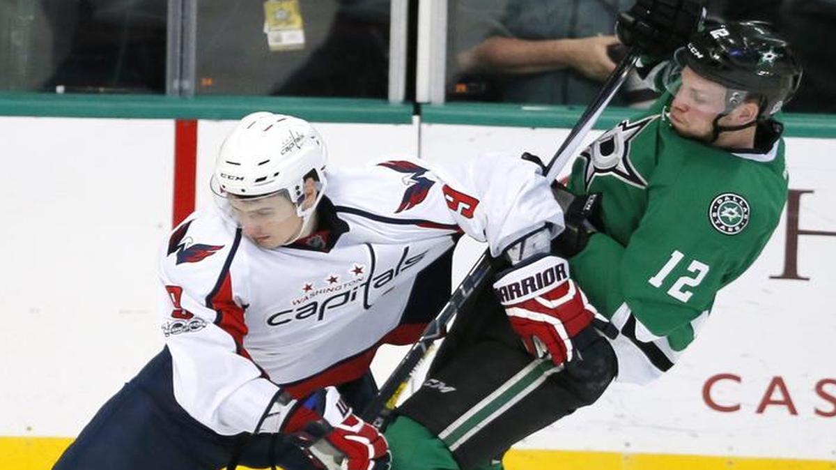 Dallas Stars forward Radek Faksa, right, is knocked off the puck by the Washington Capitals’ Dmitry Orlov in the third period Saturdy. Faksa suffered a lower-body injury late in the game and will the miss the next two games before the All-Star break.