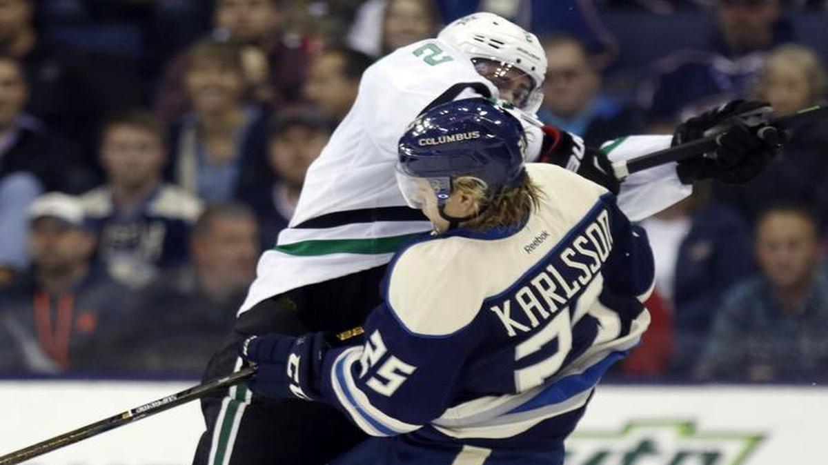 Stars defenseman Dan Hamhuis, left, collides with Blue Jackets forward William Karlsson during Tuesday’s game in Columbus, Ohio.