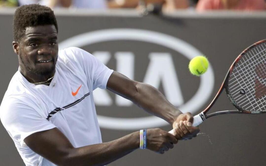 Frances Tiafoe of the United States makes a backhand return to Germany’s Alexander Zverev during their second-round match at the Australian Open in Melbourne, Australia, on Jan. 19. Tiafoe won his opening match Tuesday at the RBC Tennis Championships of Dallas.