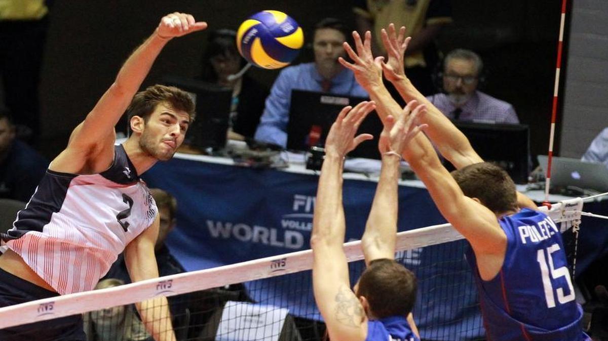 Aaron Russell (2) of the US takes a shot against Alexander Volkov (18) and Victor Poletaev (15) of Russia in the first set of an FIVB World League match at Kay Bailey Hutchison Convention Center in Dallas Sunday, July 3, 2016.