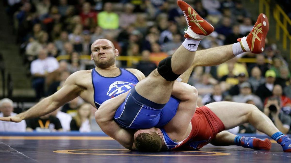 Tervel Dlagnev, top, is taken to the mat by Zach Rey during their 125-kilogram freestyle finals match at the U.S. Olympic Wrestling Team Trials on April 9 in Iowa City, Iowa. Dlagnev won the match.