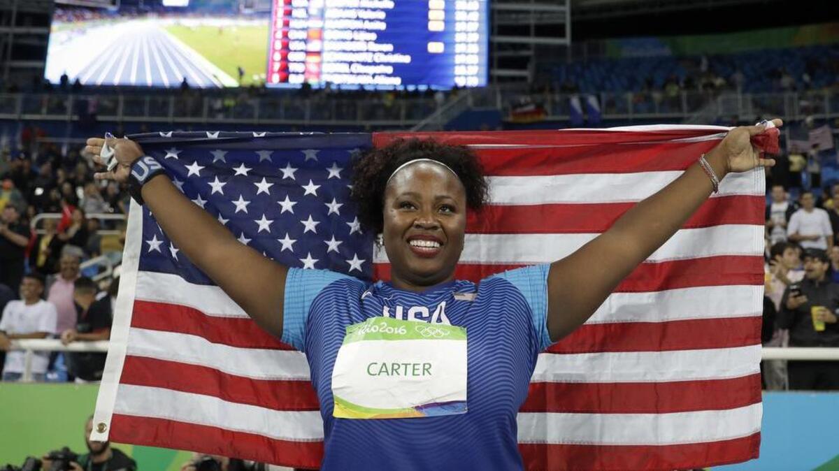 Michelle Carter celebrates winning the gold medal Friday night, beating two-time defending Olympic champion Valerie Adams on her last throw.