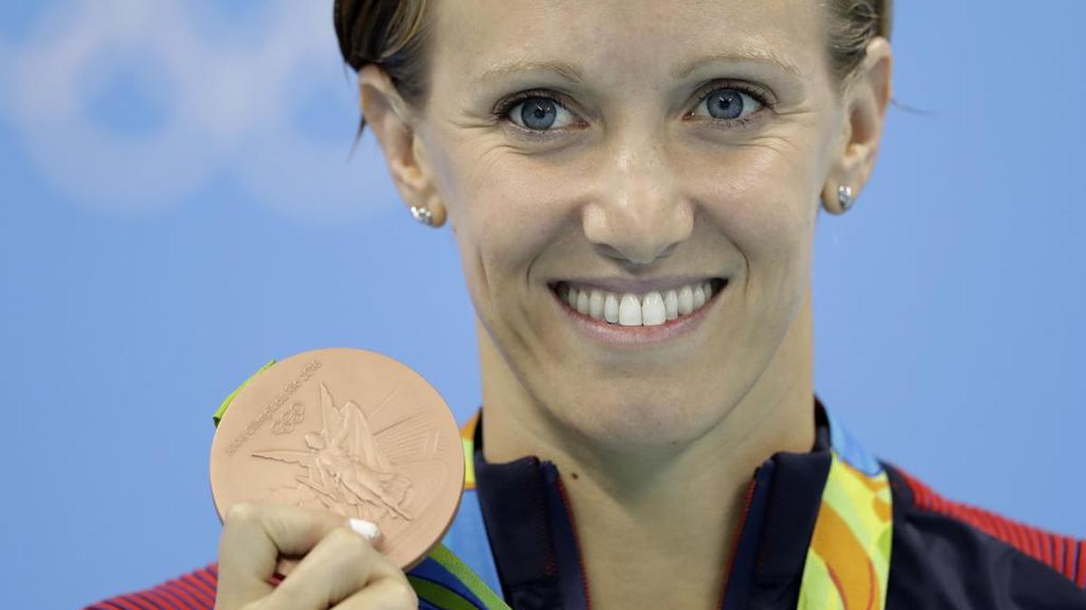 Granbury’s Dana Vollmer shows off her bronze medal during the medal ceremony for the women's 100-meter butterfly final Sunday.