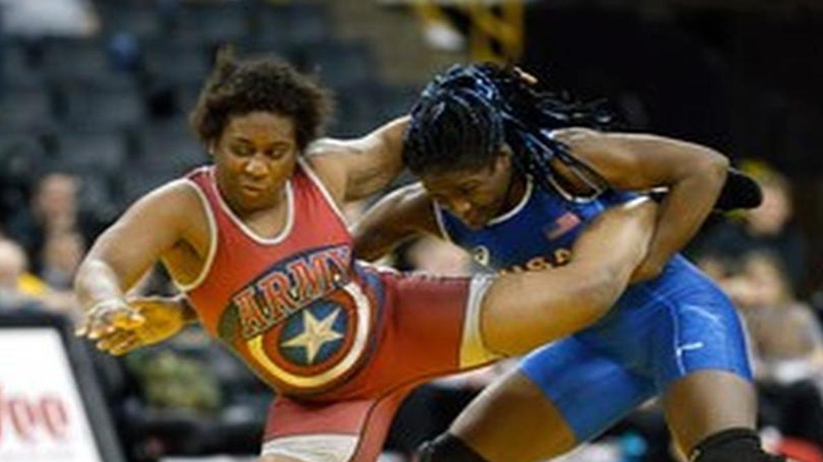 Tamyra Mensah, right, battles Randi Miller in a special wrestle-off in Iowa City earlier this year.