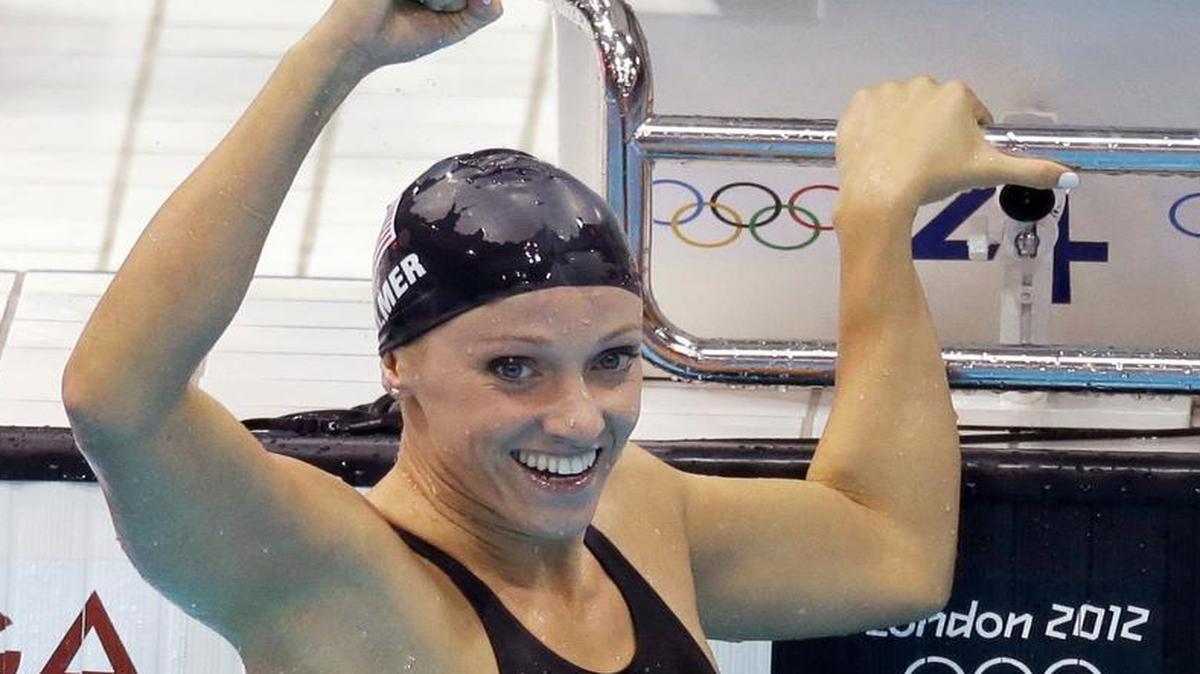
Dana Vollmer celebrates her gold medal win in the women’s 100-meter butterfly at the 2012 Summer Olympics in London.  Vollmer, who grew up in Granbury, is attempting a comeback after giving birth to her first child in March.
