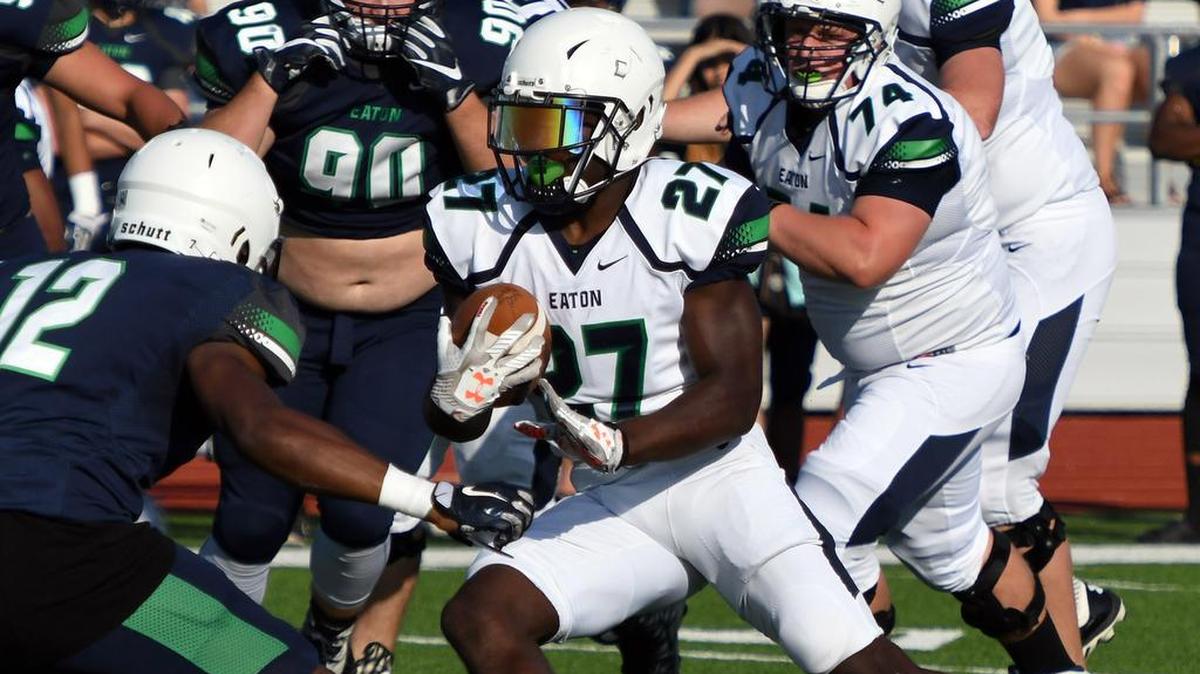 From 2017, Eaton running back Titus Swen (27) is focused on defender Oscar Moore during the Green-Navy spring game at Haslet Eaton High School.
