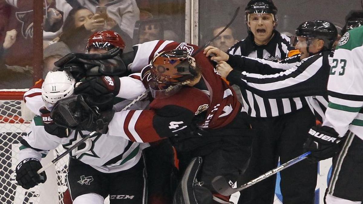 Stars wing Curtis McKenzie, left, mixes it up with Arizona Coyotes goalie Mike Smith during the teams’ matchup Dec. 27 won by Dallas 3-2. The teams will tangle again Friday at American Airlines Center. Coverage begins at 7:30 p.m. on FSSW Plus.