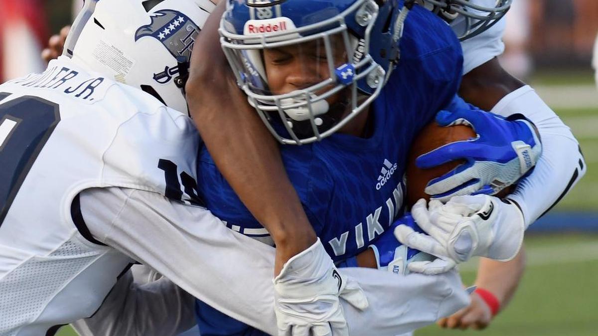 Richland defenders Demond Fowler Jr., left, and George McClendon III wrap up on Nolan Catholic’s Trae King, Aug. 31, 2017.