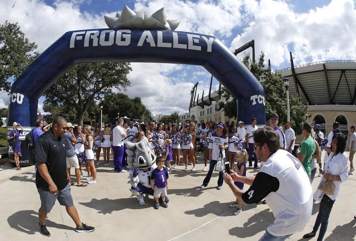 Fans in Frog Alley get their photos made with Super Frog.
