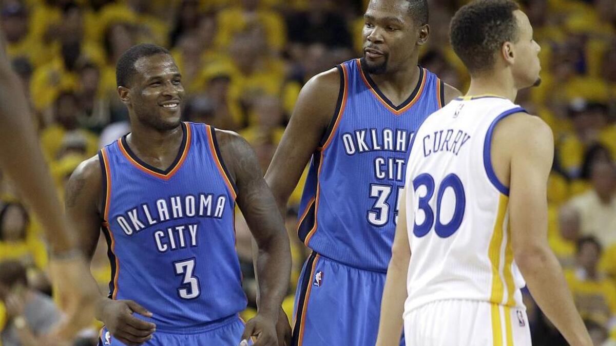 Oklahoma City Thunder guard Dion Waiters (3) smiles next to forward Kevin Durant and Golden State Warriors guard Stephen Curry (30) during the first half of Game 2. Game 3 of the Western Conference Finals will be telecast at 7 p.m. Sunday on TNT.