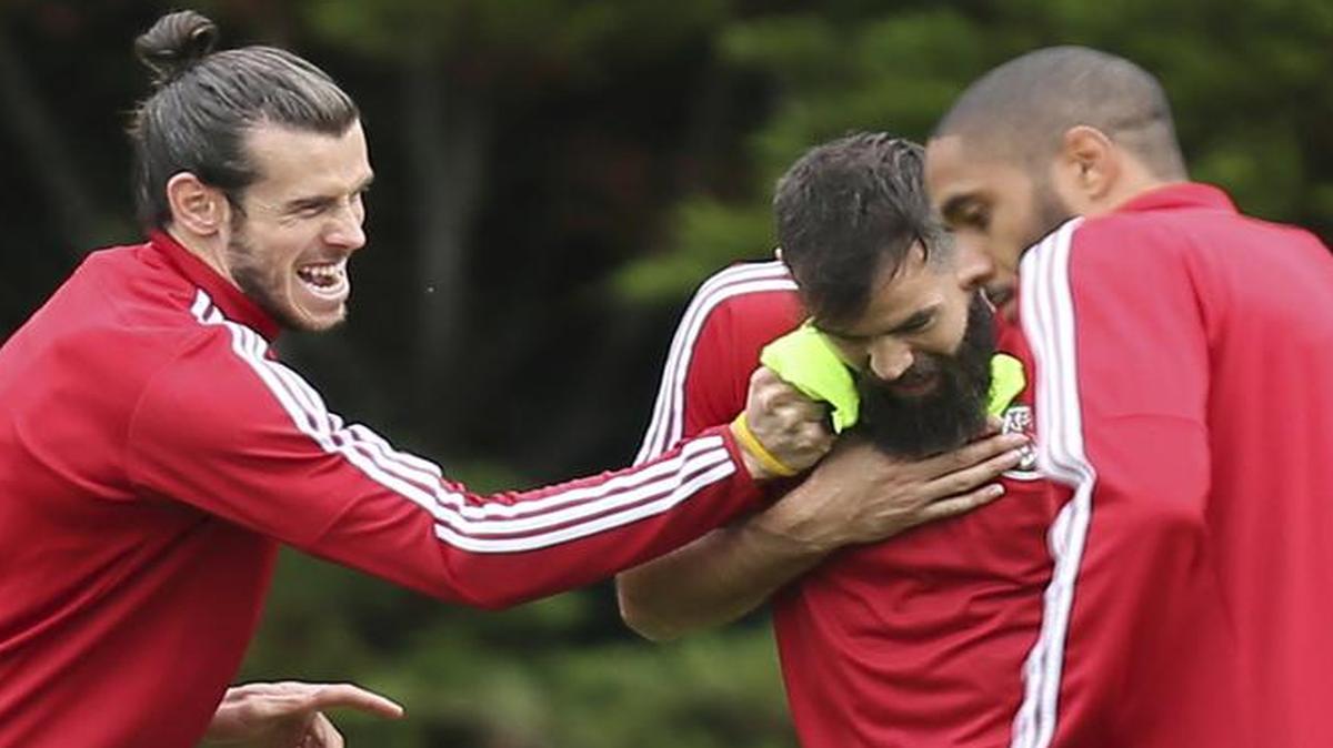 Wales star Gareth Bale, left, jokes with Joe Ledley during a training session in France on Thursday. Wales faces Belguim at 1:30 p.m. Friday on ESPN2 in a European Championship quarterfinals match.
