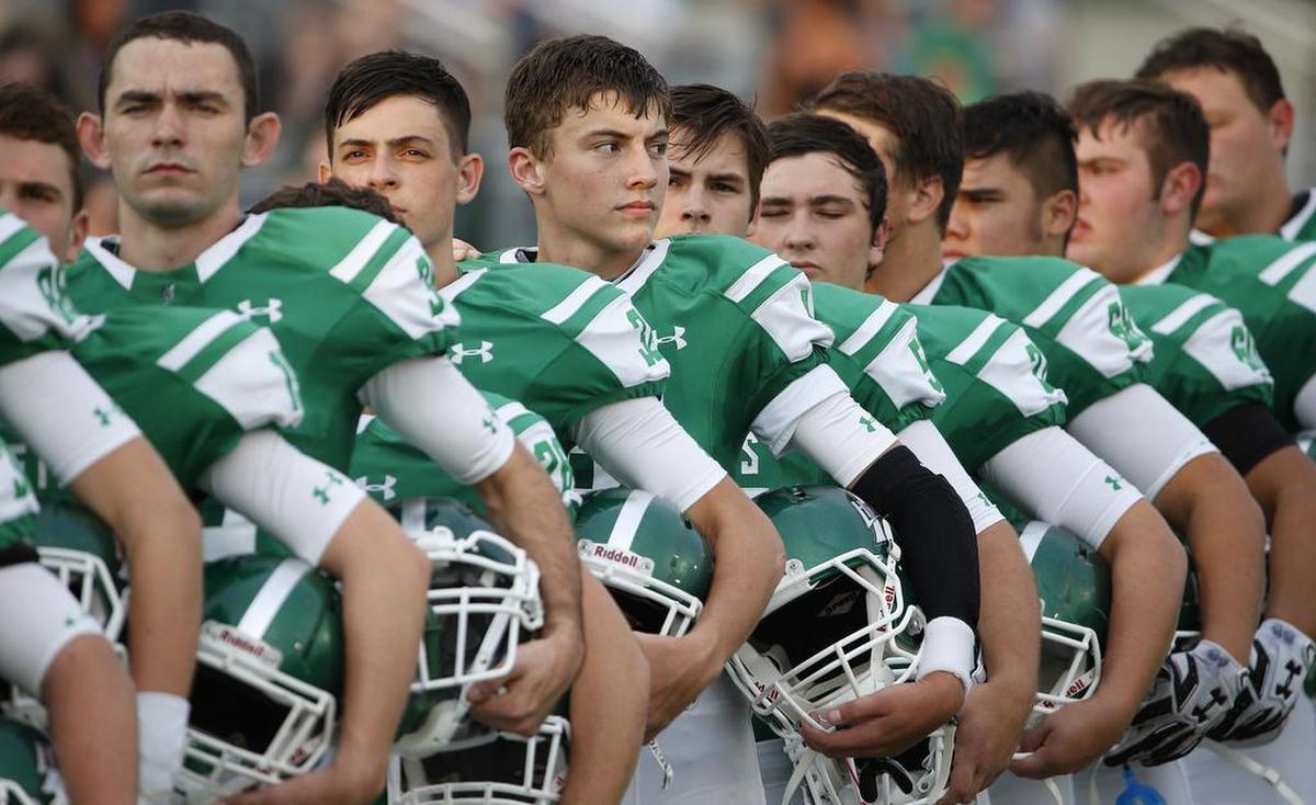 Azle quarterback Ken Seals (looking to the right) during the national anthem in 2016.