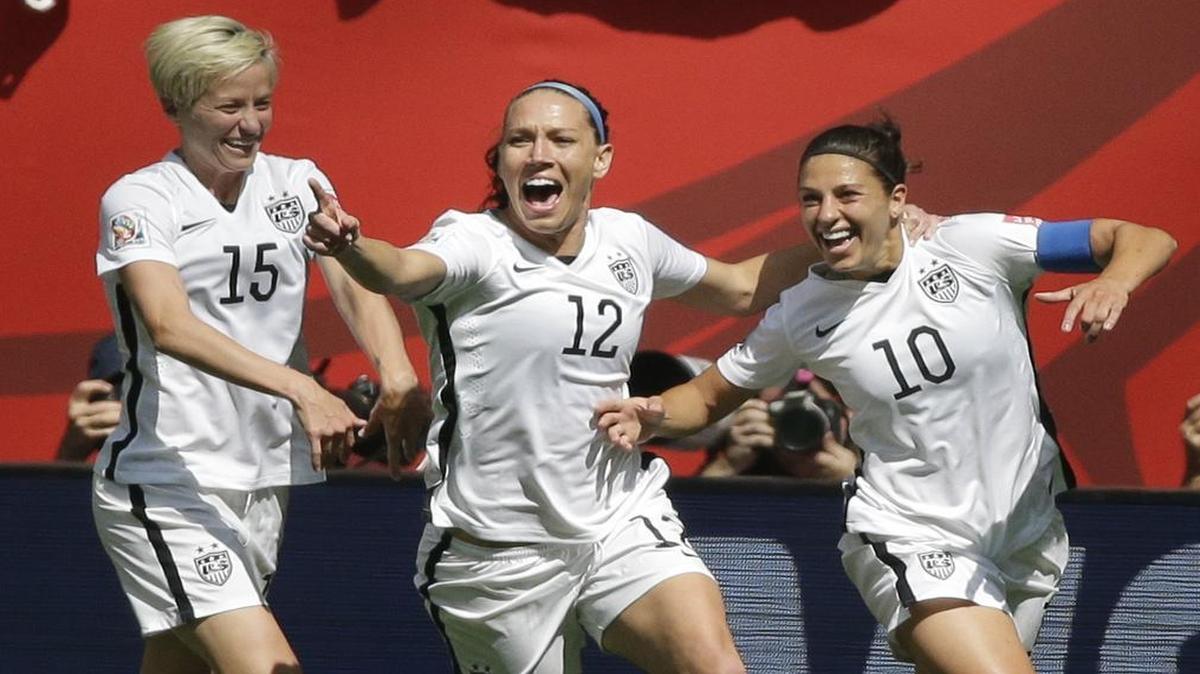 
Megan Rapinoe, left, Lauren Holiday, center, and Carli Lloyd celebrate after Lloyd’s second goal Sunday. Lloyd was awarded the Golden Ball as the tournament’s best player.



