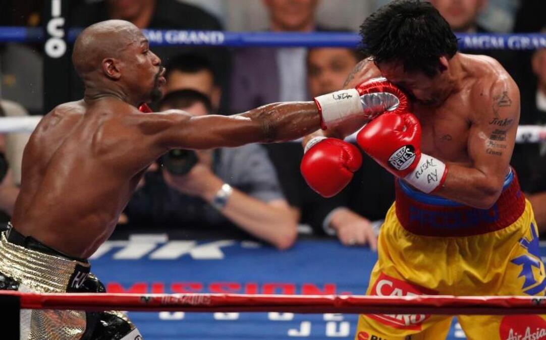 
Floyd Mayweather Jr., left, hits Manny Pacquiao, from the Philippines, during their welterweight title fight on Saturday, May 2, 2015 in Las Vegas. 
