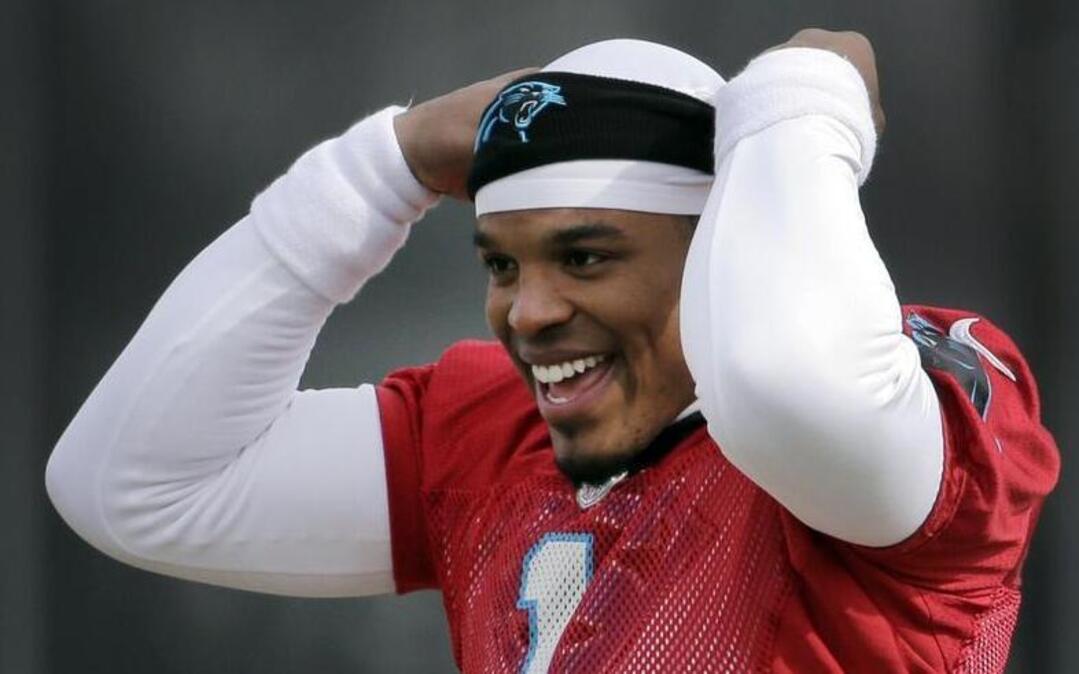 Carolina Panthers quarterback Cam Newton jokes with teammates during practice for the NFL football team in Charlotte, N.C., Wednesday. The Panthers will meet the Denver Broncos in Super Bowl 50 in Santa Clara, Calif., on Feb. 7.
