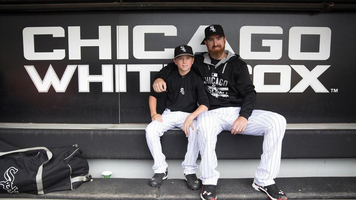 Adam LaRoche sits with his son Drake in the dugout before a game last season. LaRoche retired Wednesday after the Chicago White Sox asked him to quit bringing his son to the clubhouse so often.