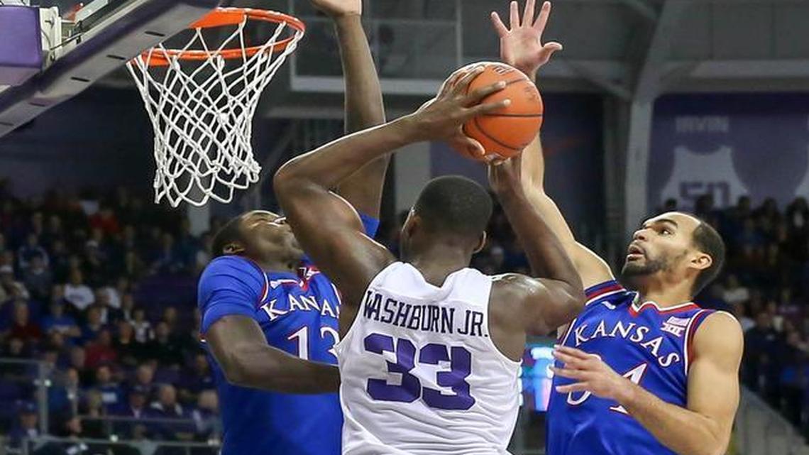 TCU forward Chris Washburn (33) goes strong to the basket against Kansas forward Cheick Diallo (13) and forward Perry Ellis, right, Saturday afternoon, at Schollmaier Arena.