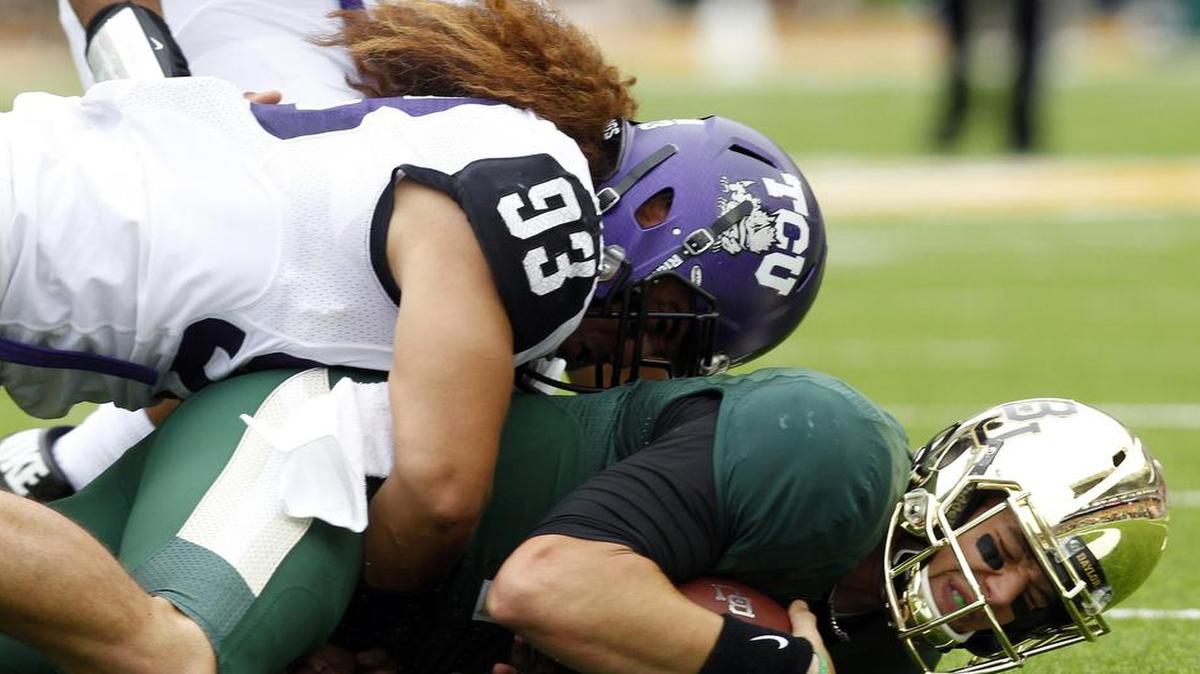 
TCU senior defensive end Mike Tuaua, sacking Baylor quarterback Bryce Petty last season, was charged — along with redshirt freshman receiver Andre Petties-Wilson — with assaulting and robbing three male students late Sept. 4. 


