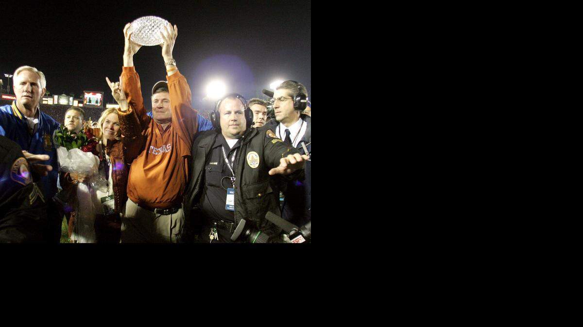 
Texas  coach Mack Brown hoists the trophy after the Longhorns’ victory over USC at the Rose Bowl in the 2005 BCS national championship game on  Jan. 4, 2006. 
