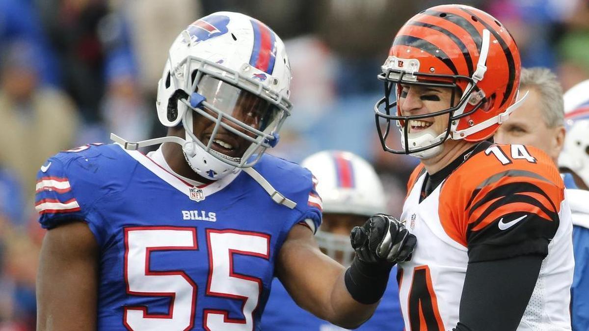 Former TCU teammates reunited: Bills defensive end Jerry Hughes (left) and Bengals quarterback Andy Dalton during their game in 2015 in Buffalo. Dalton’s last-minute touchdown pass in the regular season finale put Hughes’ Bills into the playoffs for the first time since 1999.