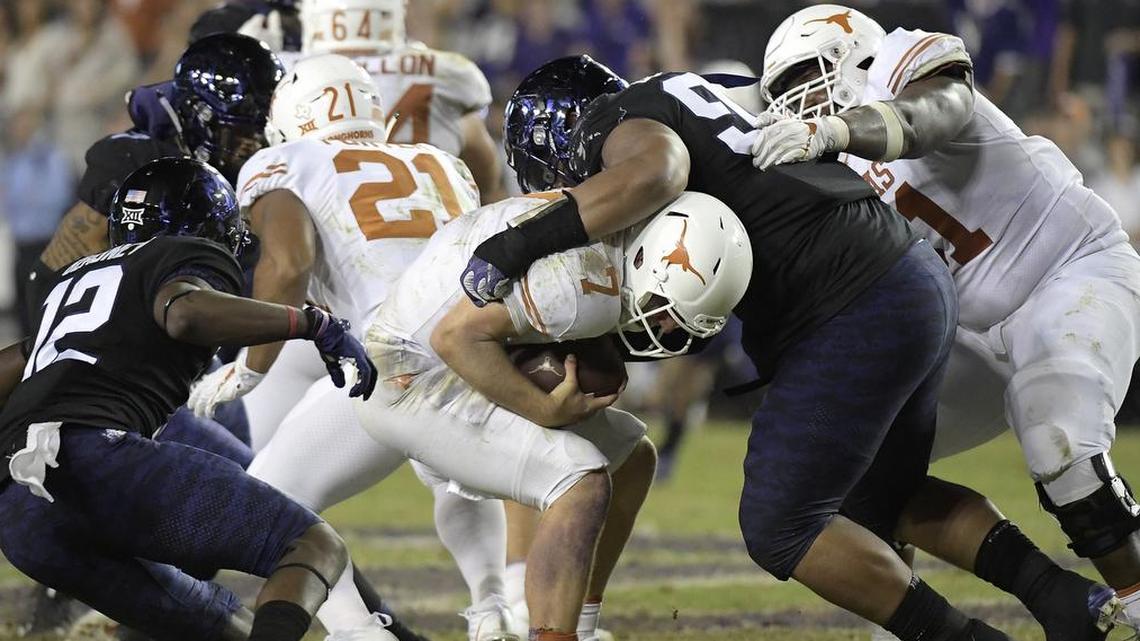 TCU’s Ross Blacklock sacks Texas quarterback Shane Buechele, one of seven the Horned Frogs recorded.