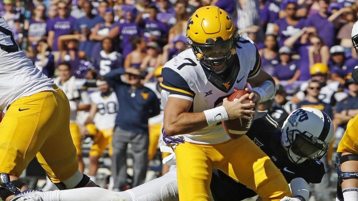TCU cornerback Ranthony Texada wraps up West Virginia quarterback Will Grier in the second quarter Saturday.