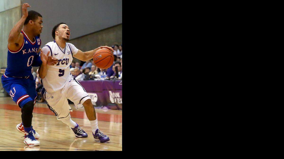 
TCU guard Kyan Anderson (5) tries to draw a foul from Kansas guard Frank Mason III. 
