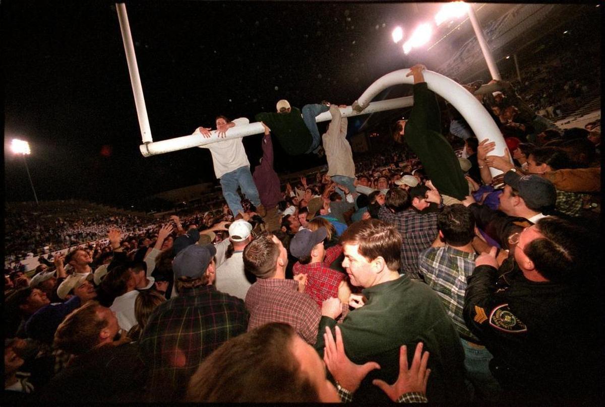 TCU fans tried to tear down the goalpost after the Horned Frogs beat SMU in 1997 for the program’s only win that year. (File photo)