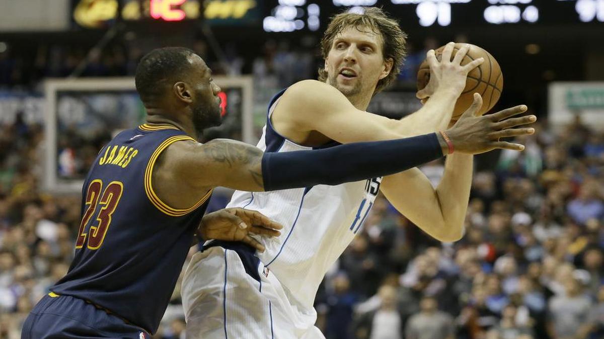 Mavericks forward Dirk Nowitzki (41) is defended by Cavaliers forward LeBron James (23) during the second half.