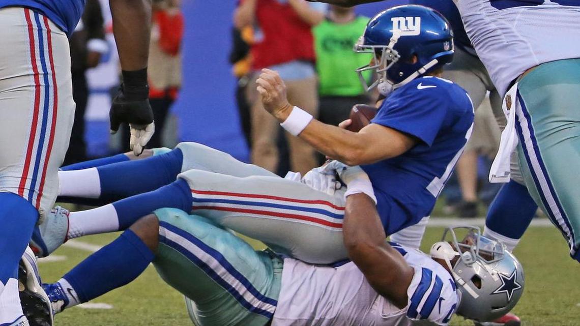 Greg Hardy sacks Giants quarterback Eli Manning.