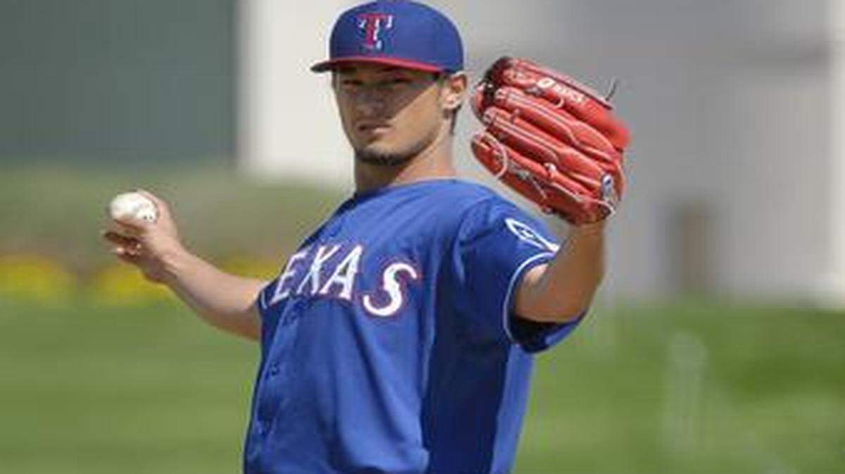 
Texas Rangers starting pitcher Yu Darvish (11) stretches before throwing during the first inning on Thursday. It appears likely it will be the only inning Darvish works this season.
