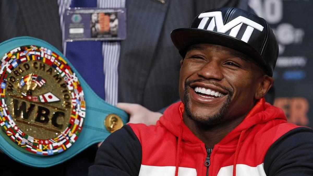 
Boxer Floyd Mayweather Jr. laughs at a news conference. No laughing matter are his guilty pleas to domestic violence. 
