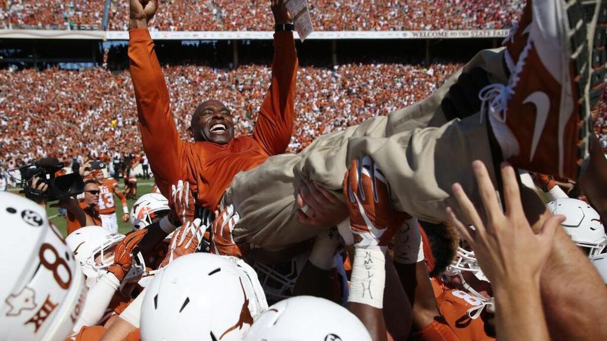 Texas needs more of this — Charlie Strong is lifted by his players after their 24-17 win over Oklahoma on Oct. 10 — for the Big 12’s image to improve.